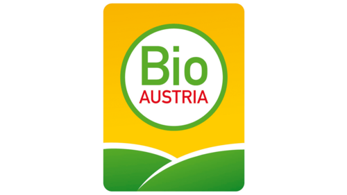 Das Bild zeigt ein Logo von "Bio Austria". Der Hintergrund ist Gelb und unten befinden sich zwei grüne Hügel und der Text "Bio Austria" steht in einem weißen Kreis mit grüner Umrandung